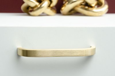 handle in brushed brass on sideboard