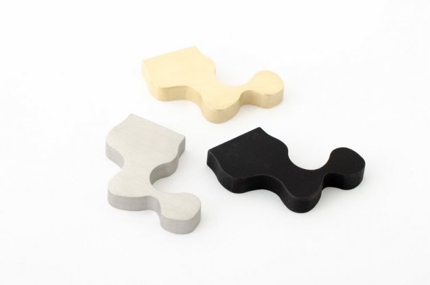 fin knopp med oregelbunden fin form i mässing, rostfritt eller svart